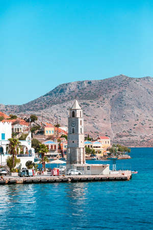 Clock tower lighthouse on the promenade in the town of Symi on the island of Symi, Greeceの写真素材