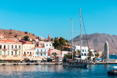 Clock tower lighthouse on the promenade in the town of Symi on the island of Symi, Greece