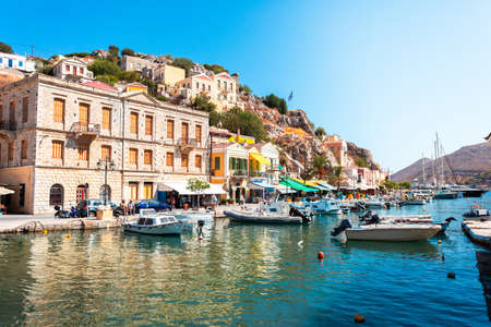 View on Greek sea Symi island harbor port, houses on island hills.の写真素材