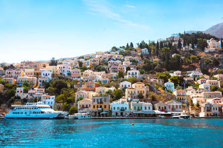 View on Greek sea Symi island harbor port, houses on island hills.の写真素材