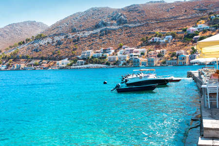 View on Greek sea Symi island harbor port, houses on island hills.の写真素材
