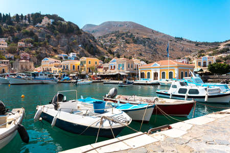 View on Greek sea Symi island harbor port, houses on island hills.の写真素材