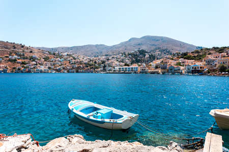 View on Greek sea Symi island harbor port, houses on island hills.の写真素材