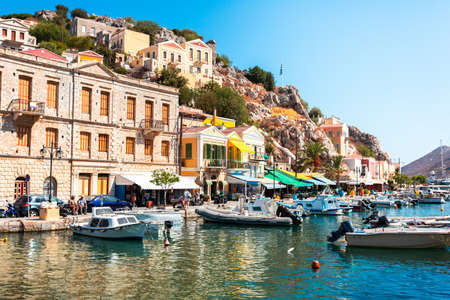 View on Greek sea Symi island harbor port, houses on island hills.の写真素材