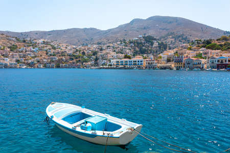 View on Greek sea Symi island harbor port, houses on island hills.の写真素材