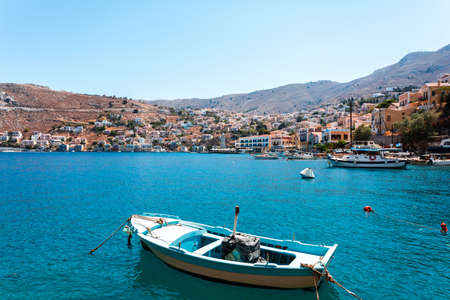 View on Greek sea Symi island harbor port, houses on island hills.の写真素材