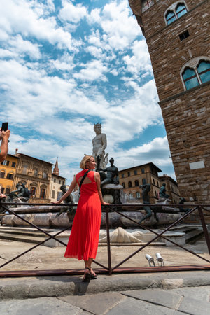 Young female traveler near famous Neptun fountain in Florence.の写真素材