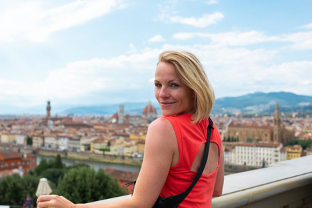 Woman stands against the backdrop of the panorama of Florence, Italy.の写真素材