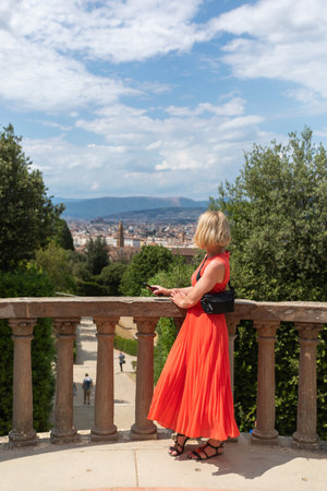 Woman stands against the backdrop of the panorama of Florence, Italy.の写真素材
