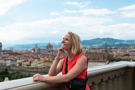 Woman stands against the backdrop of the panorama of Florence, Italy.の写真素材