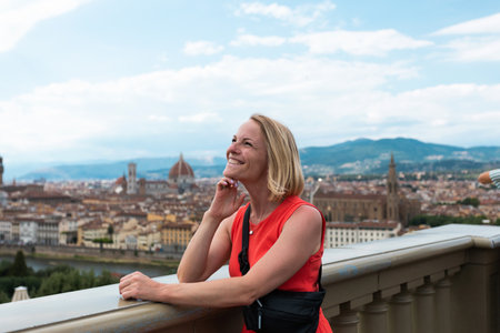 Woman stands against the backdrop of the panorama of Florence, Italy.の写真素材