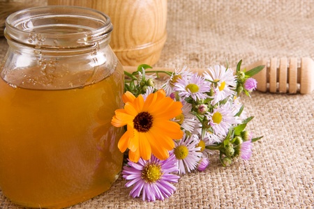 honeycomb, flowers and honey in glass on sackingの写真素材