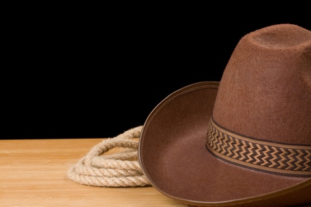 brown cowboy hat and rope isolated on black backgroundの写真素材