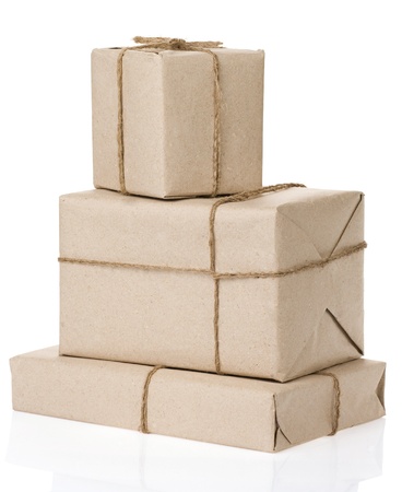 parcel wrapped with brown paper tied with rope isolated on white backgroundの写真素材