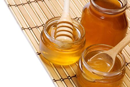 isolated pots of honey on whiteの写真素材