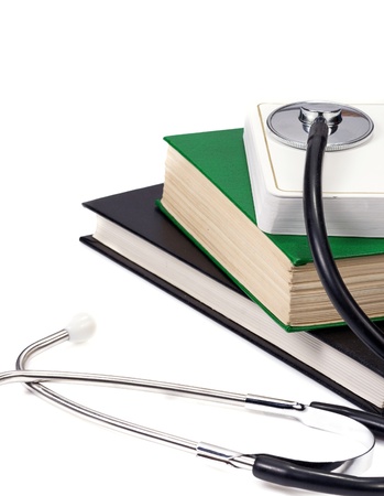 several books and stethoscope on whiteの写真素材