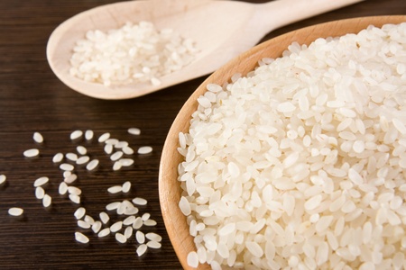 rice in plate and spoon on wooden tableの写真素材