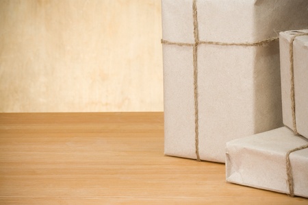 parcel wrapped packaged box on wood background textureの写真素材