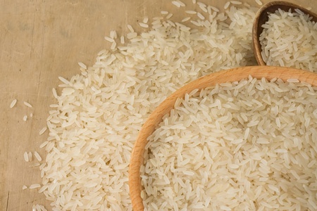 uncooked rice and wood spoon as backgroundの写真素材