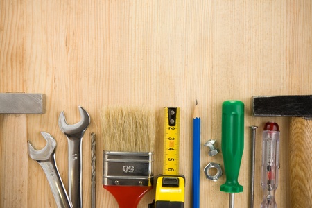 construction tools on wood background board