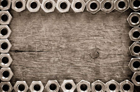 metal nuts tool on wood backgroundの写真素材