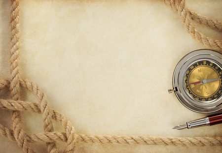 ropes and compass on old vintage ancient paper background textureの写真素材