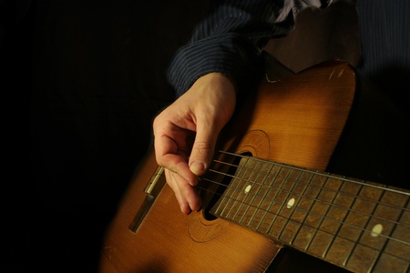 man playing classical guitar at night