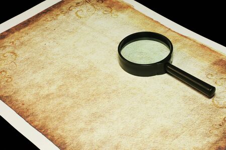 Magnifier and old sheet of paperの写真素材