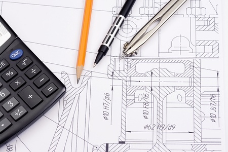 calculator and several pens on draft