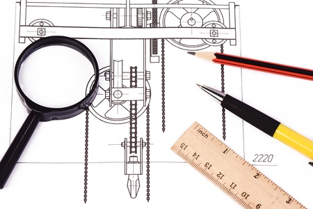 ruler, pen and magnifying glass at draft
