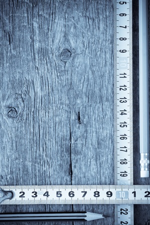 pencil and tape measure on wood textureの写真素材