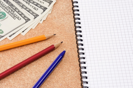 pens with pad and dollars on textureの写真素材