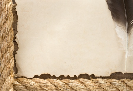 ship ropes and feather on old vintage ancient paper parchment backgroundの写真素材