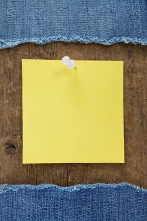 blue jean and note paper on wood texture backgroundの写真素材