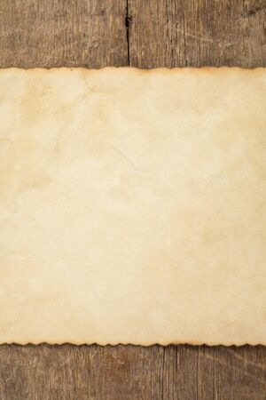 aged paper on wood backgroundの写真素材