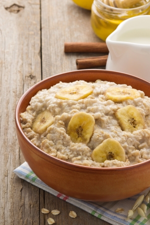 bowl of oatmeal on wood backgroundの写真素材