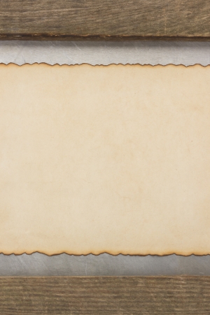 aged parchment paper and wood backgroundの写真素材