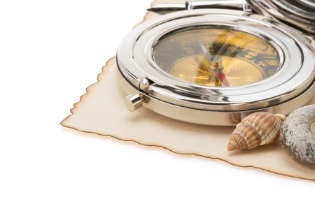 seashell and compass on old paper isolated at white background