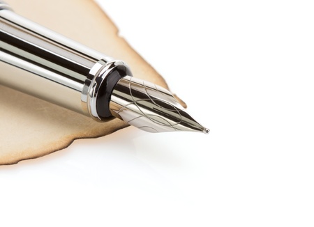 ink pen and parchment isolated on white backgroundの写真素材