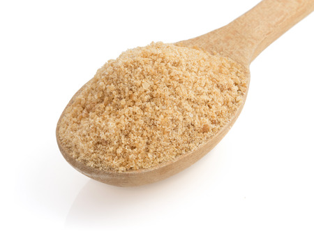 brown sugar and spoon isolated on white backgroundの写真素材
