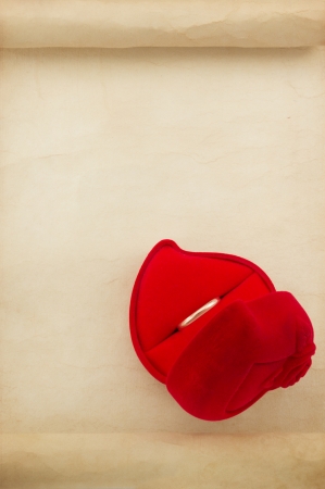 wedding ring and aged paper isolated on white backgroundの写真素材