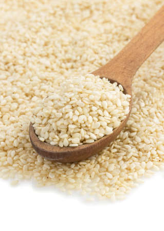 sesame seed in spoon isolated on white backgroundの写真素材