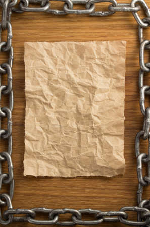 metal chain and old vintage ancient paper at wooden backgroundの写真素材