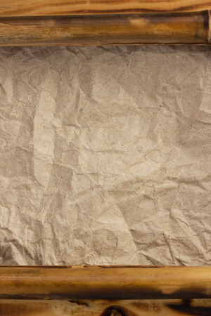 wooden frame at wrinkled paperの写真素材