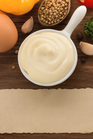 mayonnaise sauce in bowl on wooden backgroundの写真素材