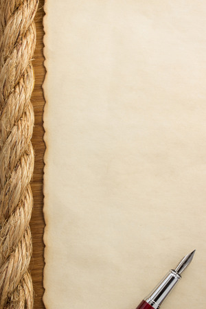 ropes and old vintage ancient paper at wooden backgroundの写真素材