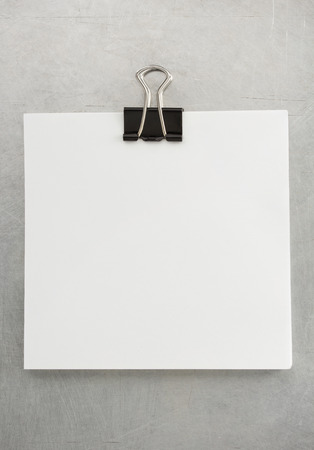 note paper and clip at metal background textureの写真素材