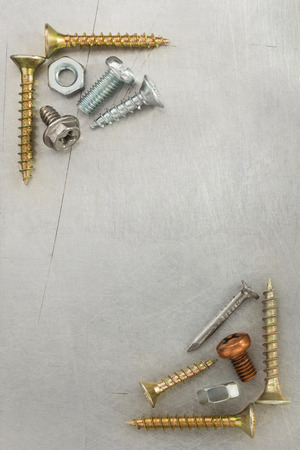 bolts, screws and nuts tool at metal background textureの写真素材