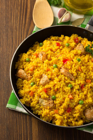 frying pan full of rice on wooden backgroundの写真素材