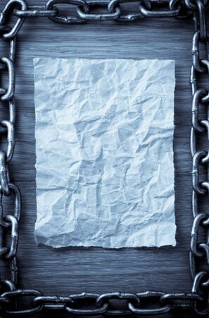 metal chain and old vintage ancient paper at wooden backgroundの写真素材